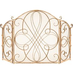 an ornate gold metal fireplace screen with scroll designs on the top and bottom panels,