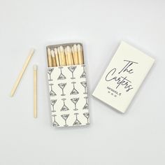 matches and matchesticks sitting on top of a white table