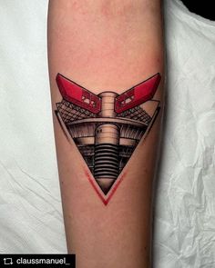 a tattoo on the leg of a person with a red object in it's center