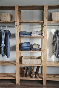 a wooden shelf filled with lots of clothes