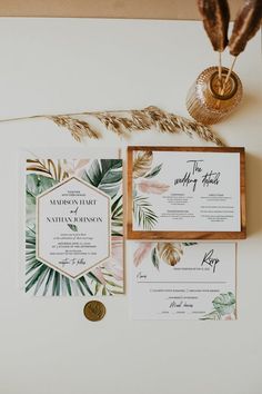 the wedding stationery was done with tropical leaves and greenery