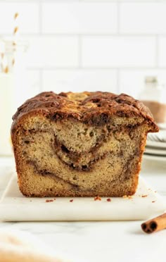 a loaf of cinnamon swirl bread sitting on top of a cutting board