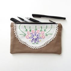 "-Vintage hand-embroidered flowers on front side -100% cotton canvas outer -Cotton twill lining -Heavy duty YKK brass zipper with antique finish -Holds up to 50 standard size pens/pencils -Handmade in Madison, WI **You'll receive the exact item pictured!! **This fabric is more delicate than my other options and is most suitable for light wear ---MEASUREMENTS--- 8 3/4\" wide 5 1/4\" high 6 1/4\" zipper opening View all medium pencil cases:  https://www.etsy.com/shop/Lindock?section_id=25371747 Vi Embroidery Pencil Case, Double Zipper Pouch, Canvas Pencil Case, Vintage Floral Fabric, Hand Embroidered Flowers, Small Laptop, Pens Pencils, Pencil Cases, Madison Wi