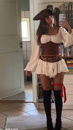 a woman in a pirate costume taking a selfie