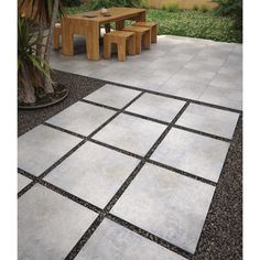 an outdoor patio with two benches and a table