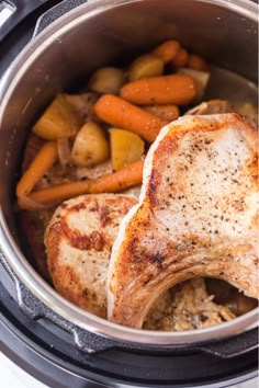 two pieces of chicken in an instant pot with carrots, potatoes and other vegetables