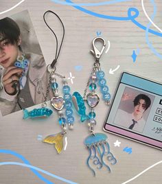 a couple of charms sitting on top of a table next to a card and photo