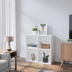 a living room with a couch, chair and television on the stand in front of it