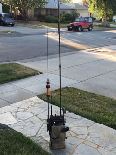 a cell phone tower sitting on top of a sidewalk