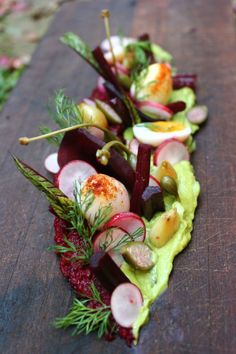 a wooden table topped with lots of veggies