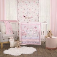 a baby's room with pink and white decor, including a teddy bear crib