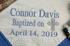 a blue and white quilt with the words, common davis baptist on it next to a cross