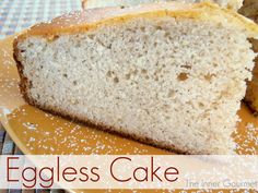 an eggless cake on a yellow plate with powdered sugar around it and the words eggless cake below