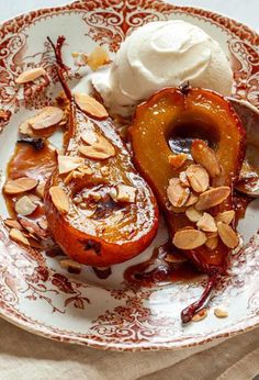 a plate topped with fruit covered in almonds and ice cream