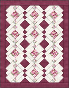 a quilted table runner with pink and green flowers on the border, in an argyle pattern