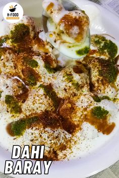 a bowl filled with food sitting on top of a white plate next to a spoon