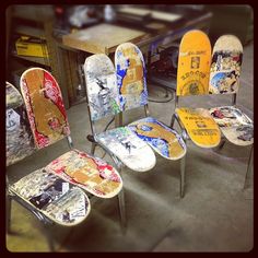 four chairs with different designs on them in a room next to a table and other items