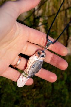 Black barn owl necklace made of  high-quality polymer clay. Completely handmade! I added a clear quartz crystal. One day I saw a photo of a real black barn owl and decided to make one just like it. Size:  2.4 inch x 0.8 inch Cord 17.7 inch 6 cm x 2.8 cm Cord 45 cm My pendant is coated with a protective finish for added durability, but to maintain its beauty, we recommend avoiding direct contact with water. If the pendant gets wet in the rain, it won't be damaged, but it's best not to soak it int Black Barn Owl, Barn Owl Necklace, Clay Owl, Black Barn, Owl Necklace, Owl Jewelry, Owl Pendant, Barn Owl, Clear Quartz Crystal