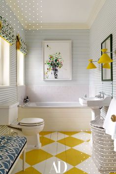 a bathroom with blue and white striped wallpaper, yellow accents, and a checkered floor