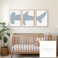 a baby's room with two paintings on the wall and a crib next to it