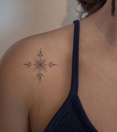 a woman with a tattoo on her shoulder