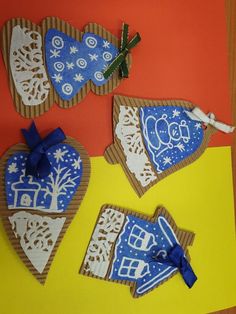 three pieces of paper cut out to look like heart shaped cookies with decorations on them