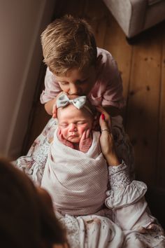 a woman holding a baby in her arms