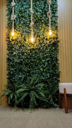 a living room with plants growing on the wall and three lights hanging from it's sides