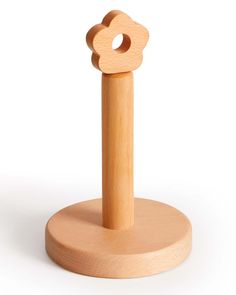 a wooden toy that is on top of a stand with the letter o in it