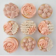 nine cupcakes with pink frosting and flowers on them