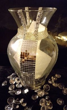 a glass vase sitting on top of a table filled with crystal stones and other items