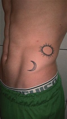 a man with a sun and moon tattoo on his stomach