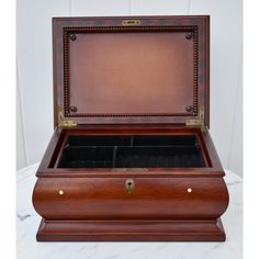 an antique wooden jewelry box with two compartments