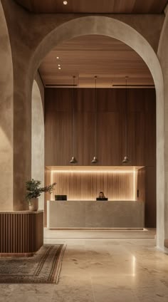 an empty lobby with two planters on the wall and lights hanging from the ceiling