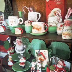 a shelf filled with christmas themed dishes and santa clause figurines