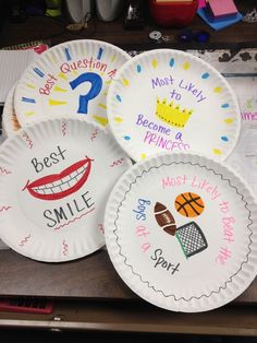 four paper plates with different designs on them