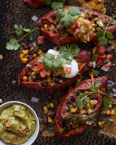 mexican stuffed red peppers topped with guacamole and cilantro