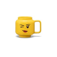 a yellow mug with a face drawn on it