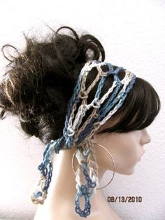 a mannequin headpiece is adorned with crocheted chains and hair clips