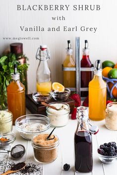 the ingredients for blackberry shrub with vanilla and ear grey are displayed on a white table