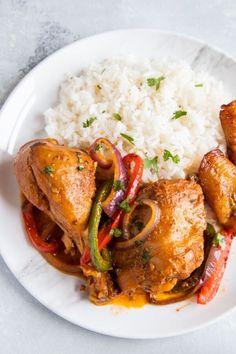 a white plate topped with chicken and rice