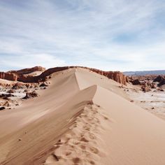 footprints in the sand on top of a hill