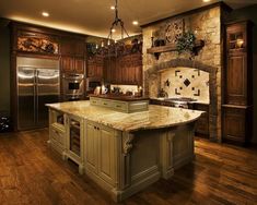 a large kitchen with wooden floors and granite counter tops, an island in the middle