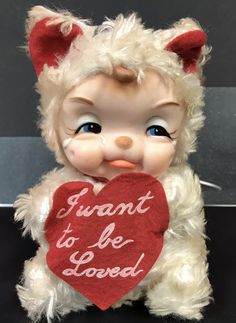 a teddy bear holding a heart that says i want to be loved