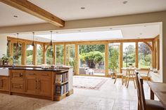 an open kitchen and dining room with large windows