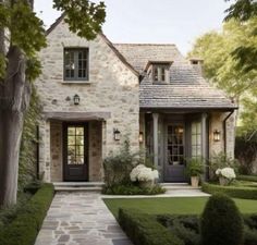 a house that is surrounded by hedges and trees