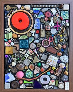 a wooden frame with many different items on it and a red object in the middle