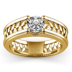 a yellow gold ring with a diamond in the center and an intricate band around it