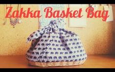 a basket with an elephant print on it and the words zaka basket bag written in red