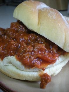 a sloppy joe sandwich sitting on top of a plate